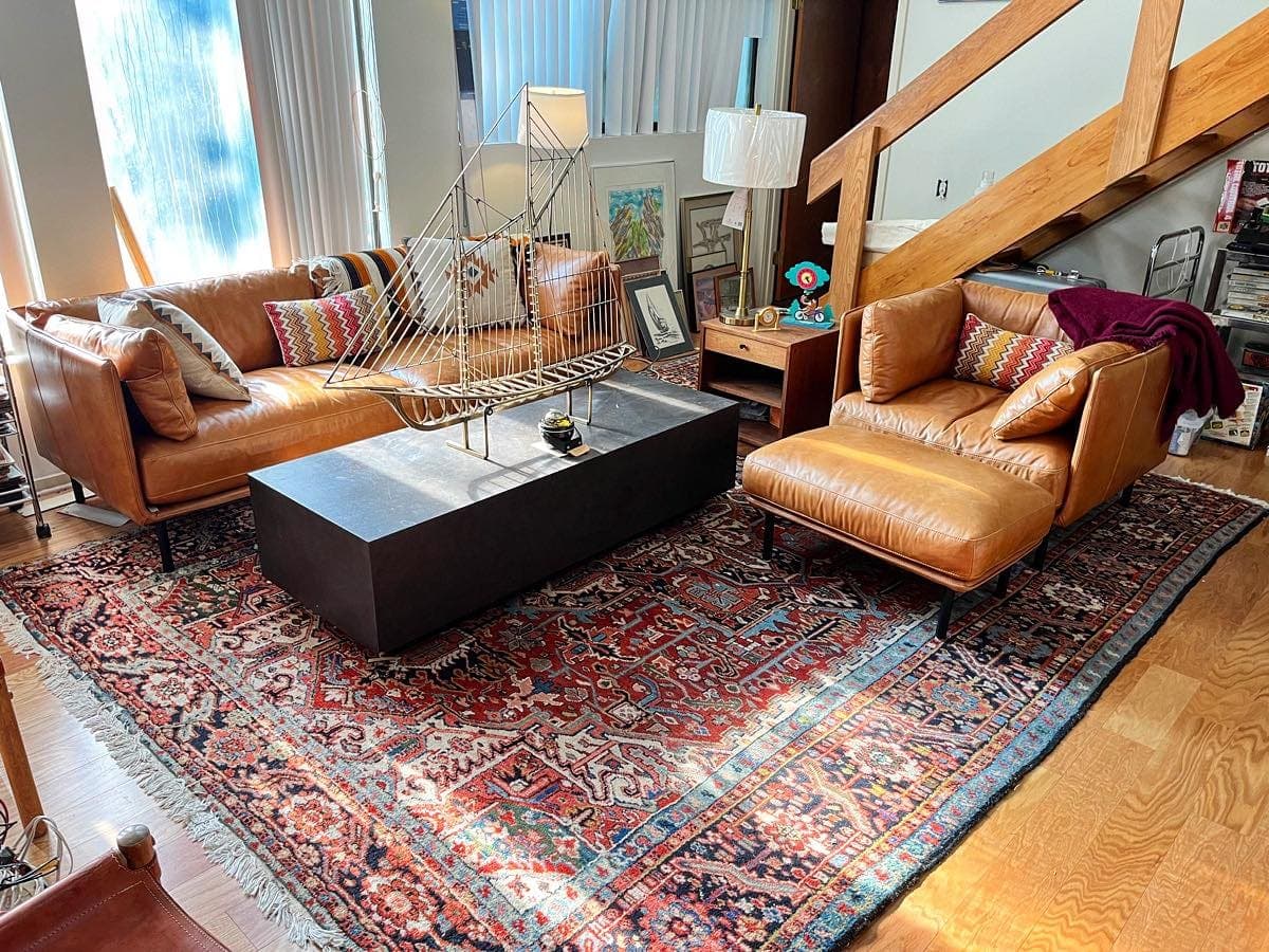 Estate living room with leather sofas and an oriental rug staged for a GoldenTree consignment sale