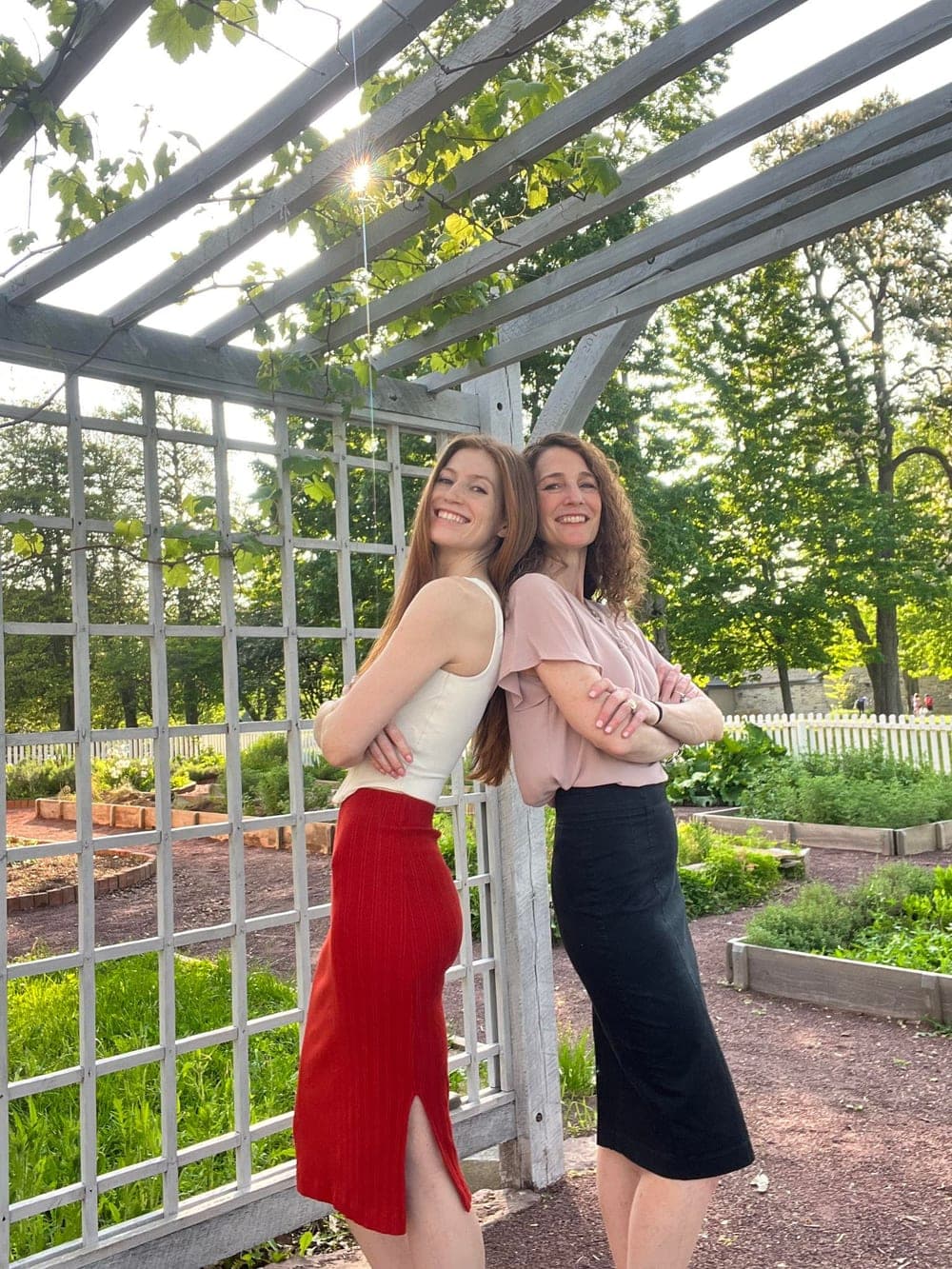 Anne and Morgan Goldenbaum of GoldenTree Estate Sales at a garden trellis
