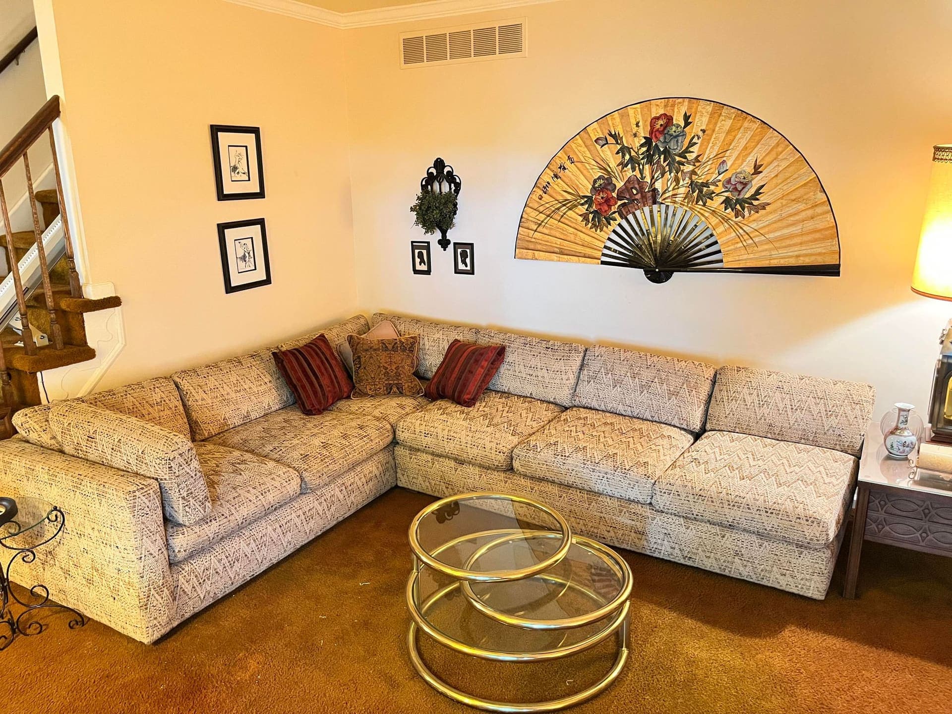 Vintage living room with sectional sofa and wall art cataloged for a GoldenTree estate auction