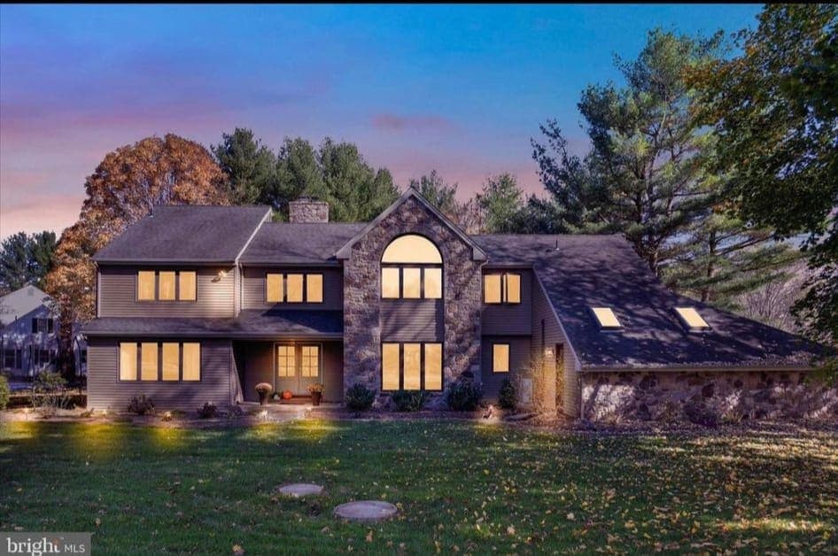 Stone estate home at dusk listed with GoldenTree in Bucks County, Pennsylvania